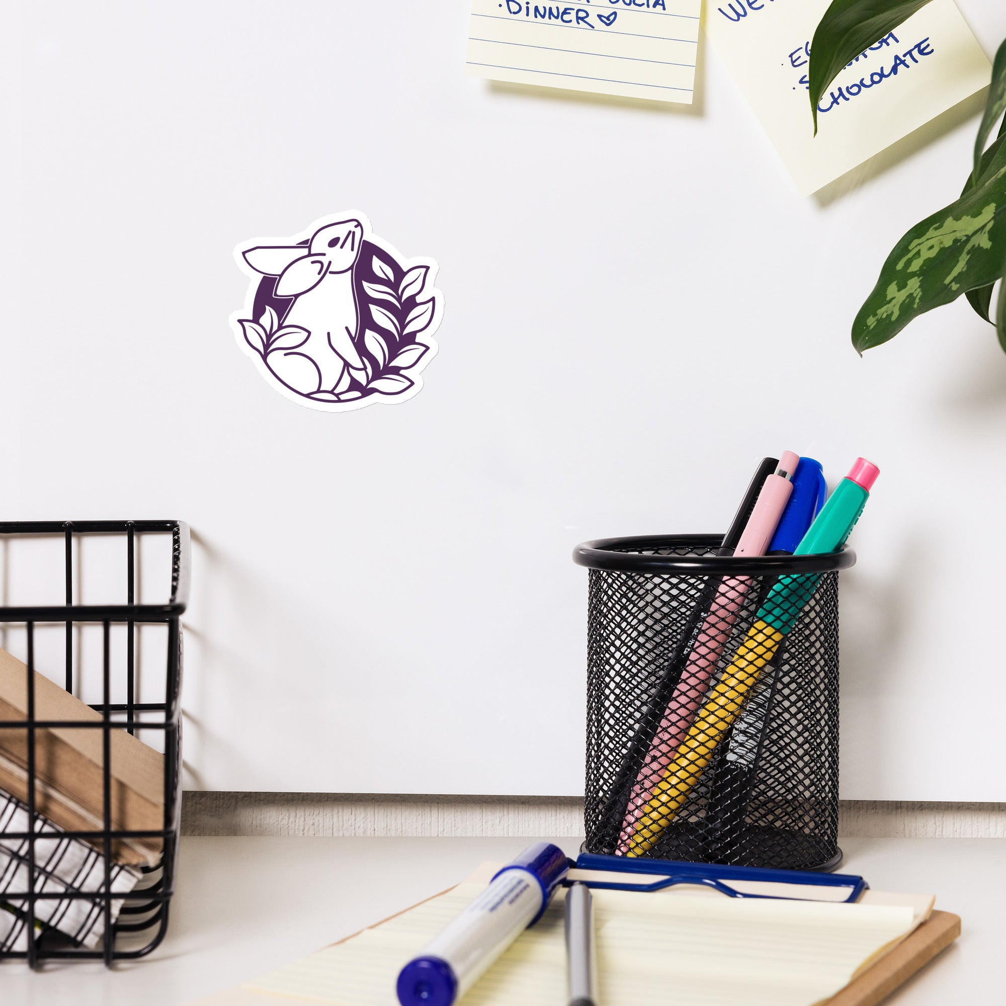 Bunny with leaves crest version of the Stories of Wonder logo mounted on an office whiteboard.